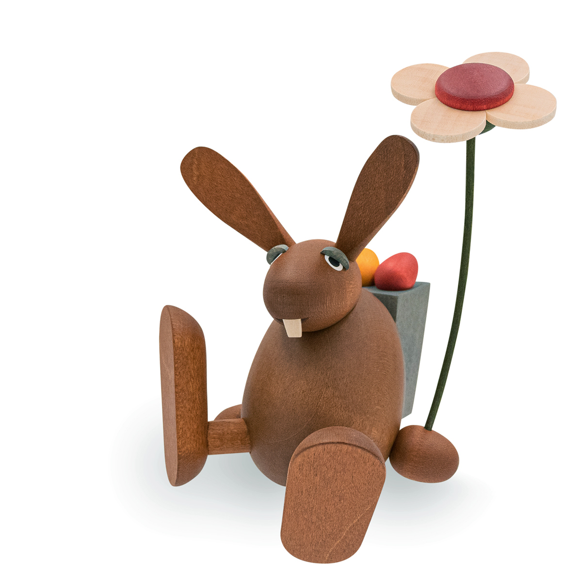 Osterhase mit Blume auf Kante sitzend / tanzend