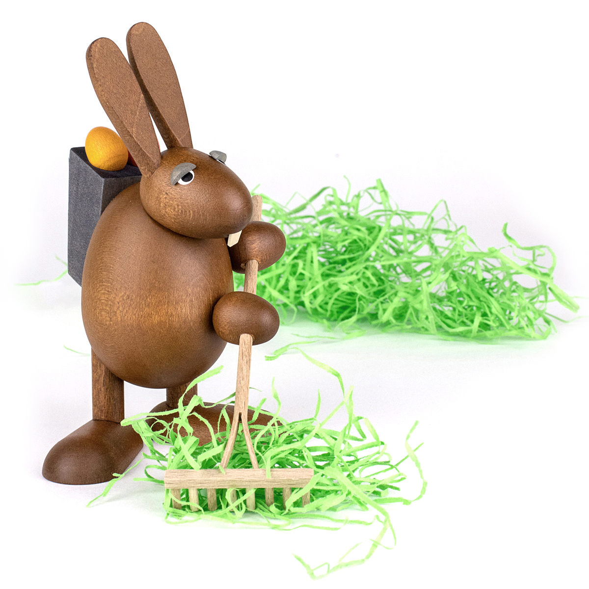 Easter Bunny with garden rake an easter grass